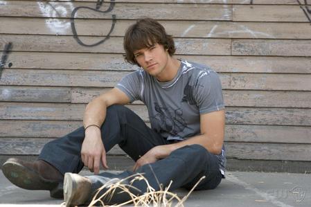 It's a season two promotional pic, so that should narrow it down. [url=http://www.supernaturalfansonline.com/gallery/thumbnails.php?album=116&page=2]here's[/url] one with just jared sitting down, from [url=http://www.supernaturalfansonline.com/gallery/thumbnails.php?album=116]this[/url] album. and [url=http://www.supernaturalfansonline.com/gallery/thumbnails.php?album=118&page=1]here's[/url] the gallery of season two promo pics with jensen and jared together, although i'm guessing the one you want is this one with just jared.