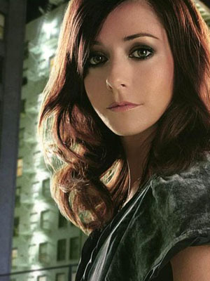 Dark auburn (redish brown). I guess this would be closest to her natural