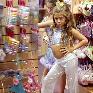 Jillian Herrera, 8, poses amid accessories at Sweet & Sassy, one of several chains that have carved a niche in the $16-billion hair salon industry by catering to children.