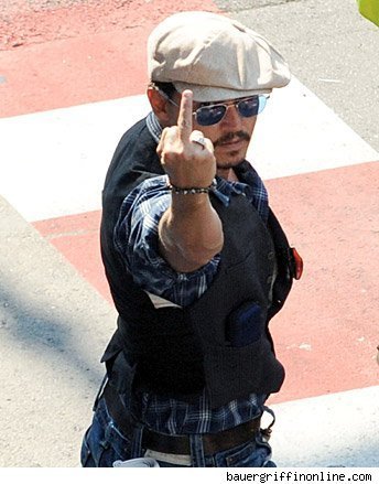 He puts his middle finger up, and we forgive him. Cause he's Johnny and we love him