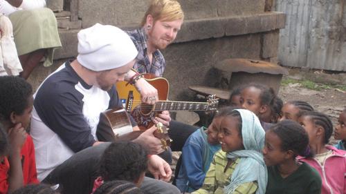  "Enjoying our time in Africa with @UNFoundation...." David and Neal playing for girls in Ethiopia