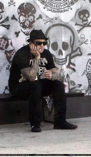 BENJI SMOKES A CIGARETTE, AND DRINKS A BEER IN FRONT OF DCMA SHOP 