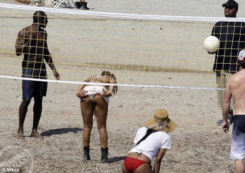 Playing volleyball on beach in Athens, Greece - June 1, 2010
