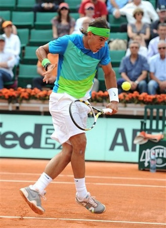 Spain's Rafael Nadal returns the ball to France's Gianni Mina during their first round match