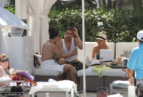 Kim hangs out poolside with friends in Miami 6/12/10