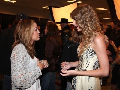  Miley and Taylor at Nashville rising a benefit concerto backstage