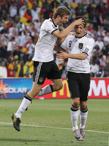 Thomas  Müller celebrating his  goal with Mesut