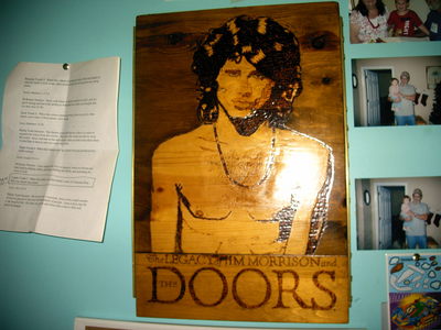  For the DieHard Jim Morrison Fans, I have a portrait of Jim that is carved into a piece of wood, varnished and the whole shabang, very well taken care of, I have added the portrait below, What do yall think it might be worth?Please be honest!!