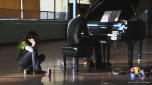  he plays the piano totally sure. in this pic he's practicing =), behind scenes.