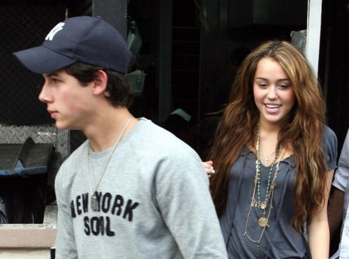  How old are Miley and Nick in this photo?