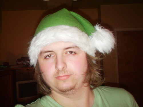  J in a green Krismas hat