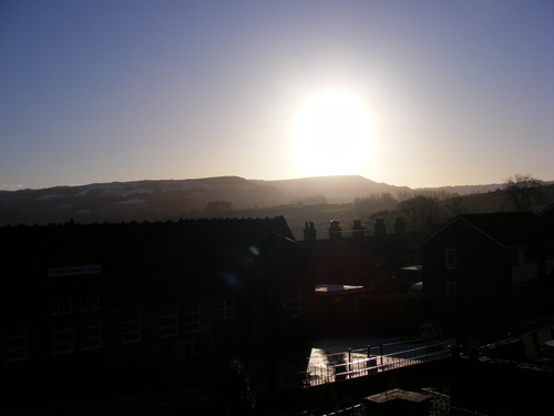 sunrise over snowy hill and playground
