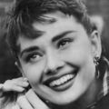 Audrey adjusting her earring on the set of Sabrina - sabrina-1954 photo