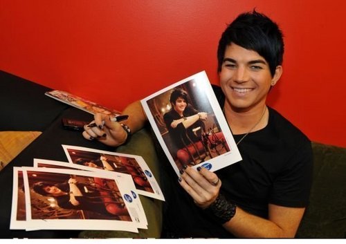 Adam signing photos