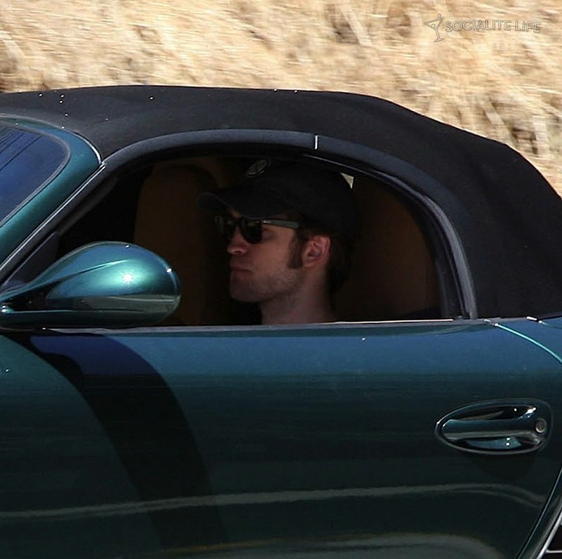 Robert Pattinson is driving away from Kristen Stewart's house in a Porche