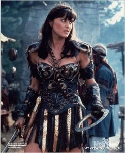  Who does Xena save from a burned down village in the episode The Gauntlet?
