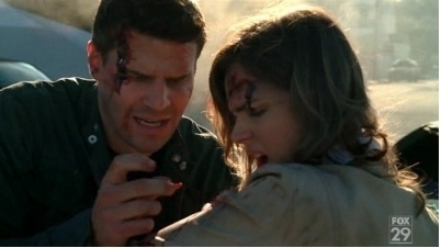 What is Booth taking out of her arm!