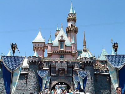 What was the cost to build Disneyland (in Anaheim) by the time it opened in 1955?