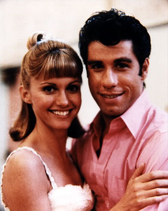  In "Grease" what color is the scarf Cha Cha is wearing the araw of the big race ?