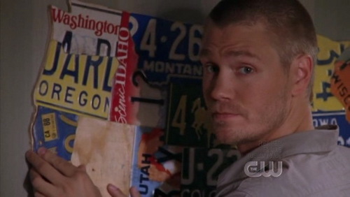 When Lindsey arrives, what license plate did Lucas put on the wall ?