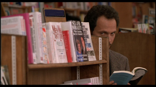 What section of the bookstore is Harry standing in when he meets Sally for the third time?
