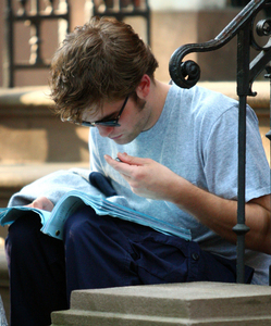  Rob studying while resting at the Remember Me set
