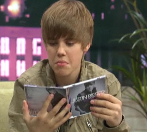  Justin Bieber looks at his album
