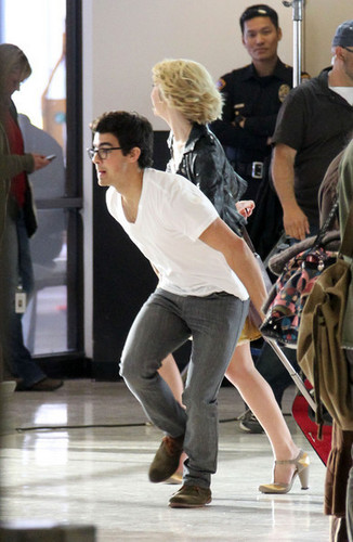  Joe Jonas&Chelsea Staub film scenes for the upcoming Jonas TV toon for the Disney Channel@LA airport