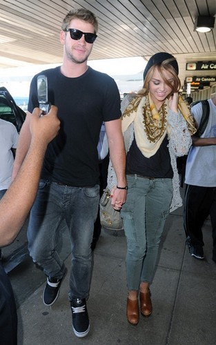 Miley Cyrus and Liam Hemsworth at LaGuardia Airport (June 18).