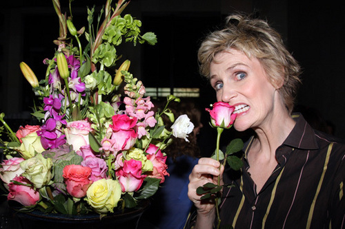 Jane biting a flower