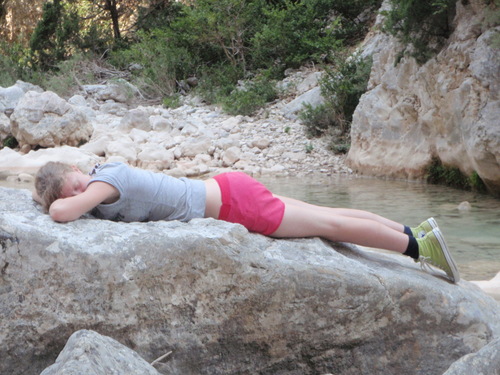 Margot sleeping on a rock in Spain